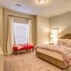 Large bedroom with carpet and ceiling fans 